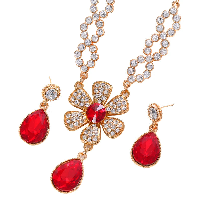 The two-piece set featuring flower elements with rhinestone inlays, earrings and necklace, highlights elegant charm.