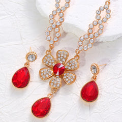The two-piece set featuring flower elements with rhinestone inlays, earrings and necklace, highlights elegant charm.