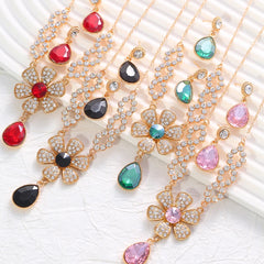 The two-piece set featuring flower elements with rhinestone inlays, earrings and necklace, highlights elegant charm.