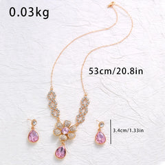 The two-piece set featuring flower elements with rhinestone inlays, earrings and necklace, highlights elegant charm.