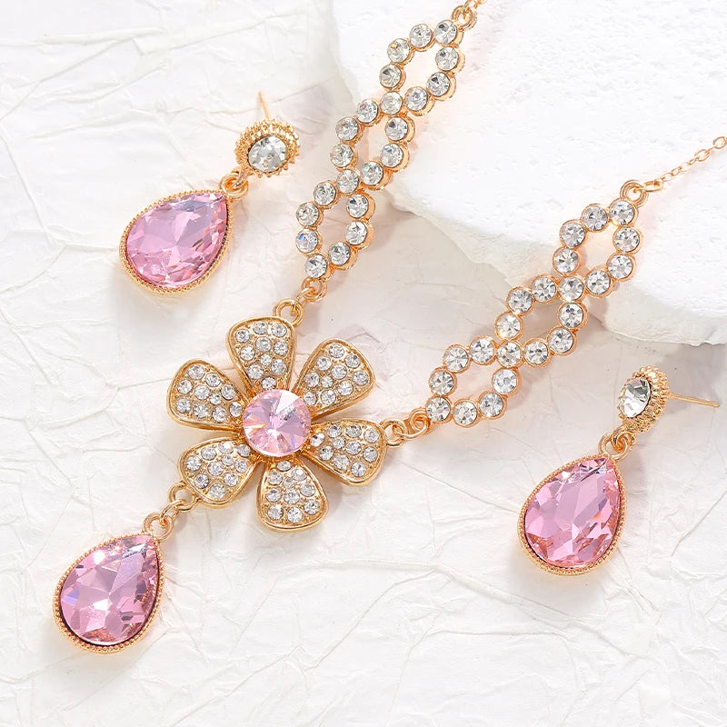 The two-piece set featuring flower elements with rhinestone inlays, earrings and necklace, highlights elegant charm.